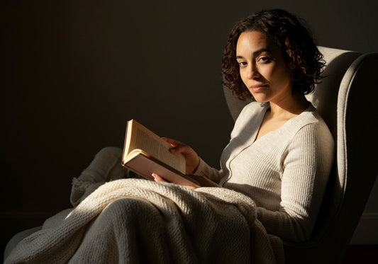 Woman in a soft ribbed loungewear set reading in a cozy chair
